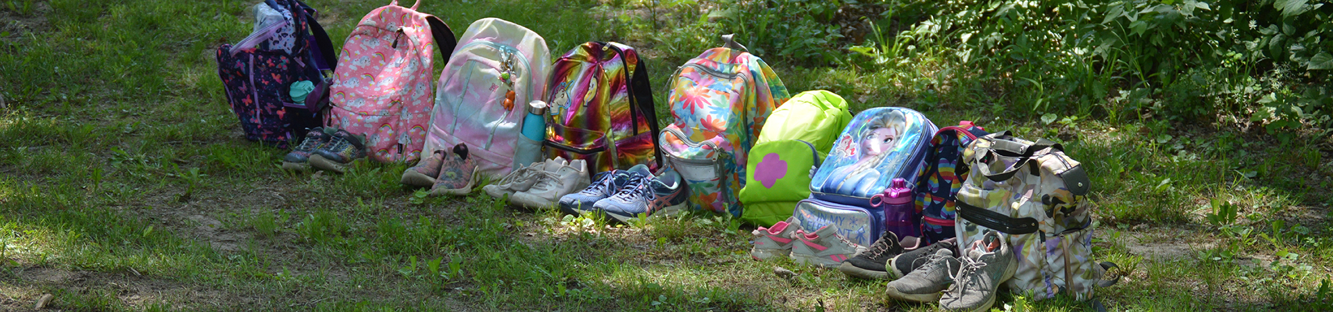  row of girl scout back packs at camp 