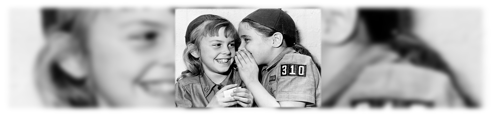  historic photo of girl scouts whispering 