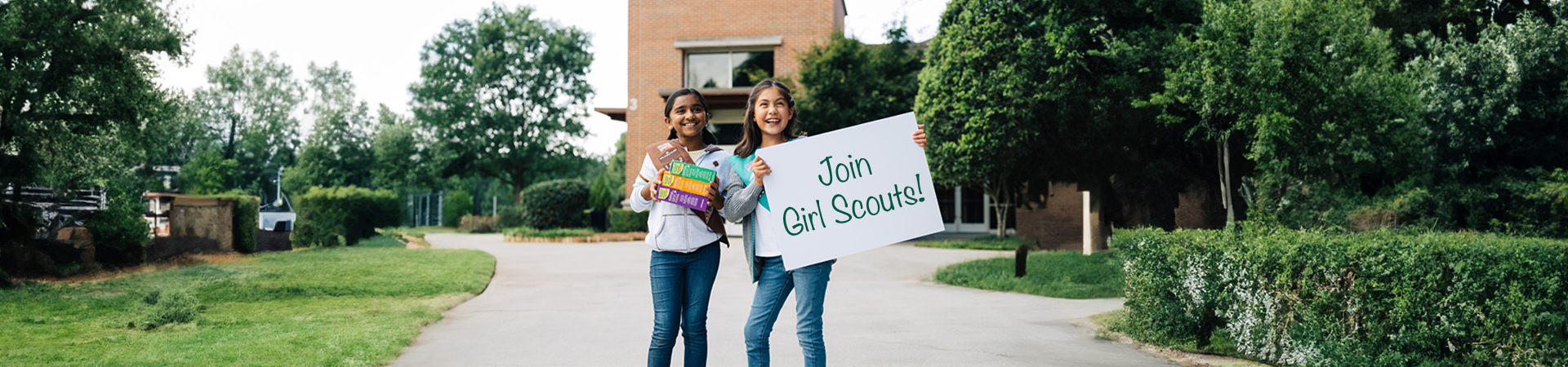  Group of Junior Girl Scouts smiling and laughing outdoors 